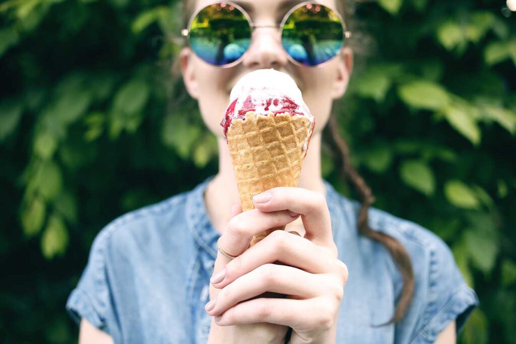 Girl in sunglasses eating ice cream