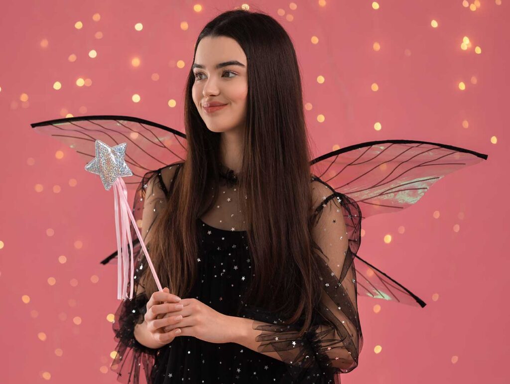 Girl in a fairy costume holding a wand