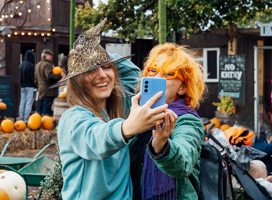 Two women at a Halloween Festival taking a selfie