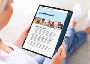 woman holding a tablet with the early learning math guide 